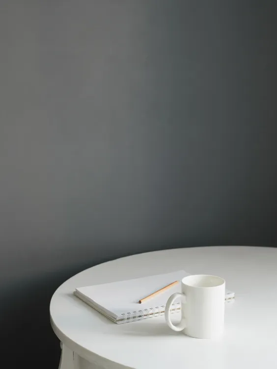 Grey wall and white table